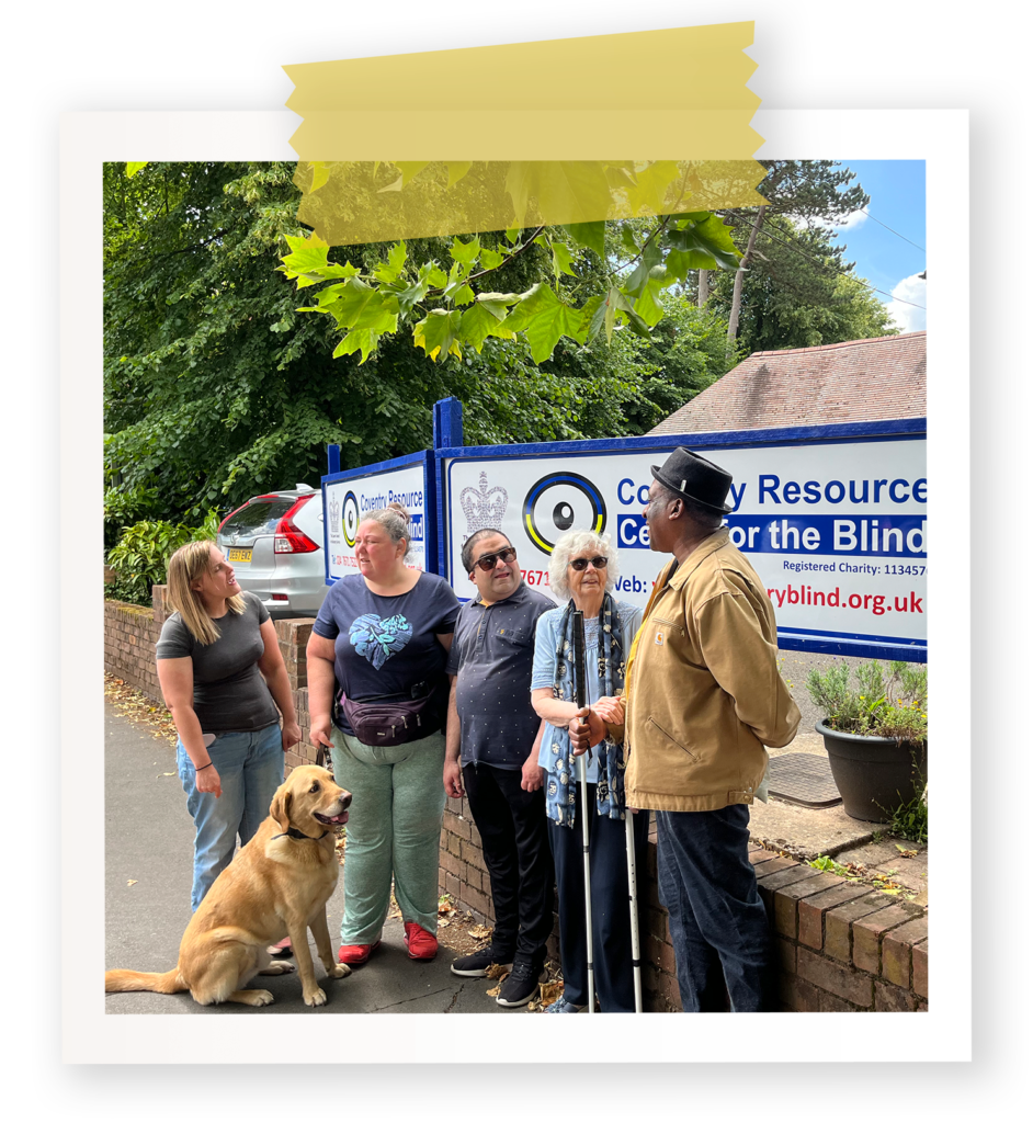 Five visually impaired people and one guide dog standing by the main sign for Coventry Resource Centre for the Blind, with the building in the background