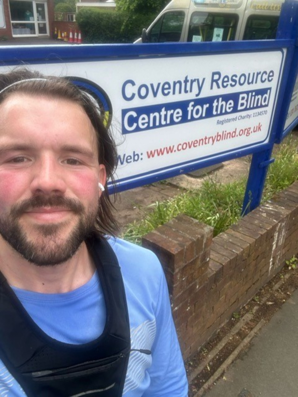 Jack Mitchell standing next to the Resource Centre sign while training for the Tallinn marathon