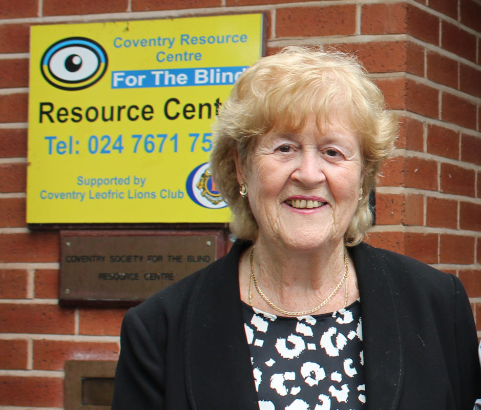 Our late co-founder, Rosie Brady, standing near the CRCB sign