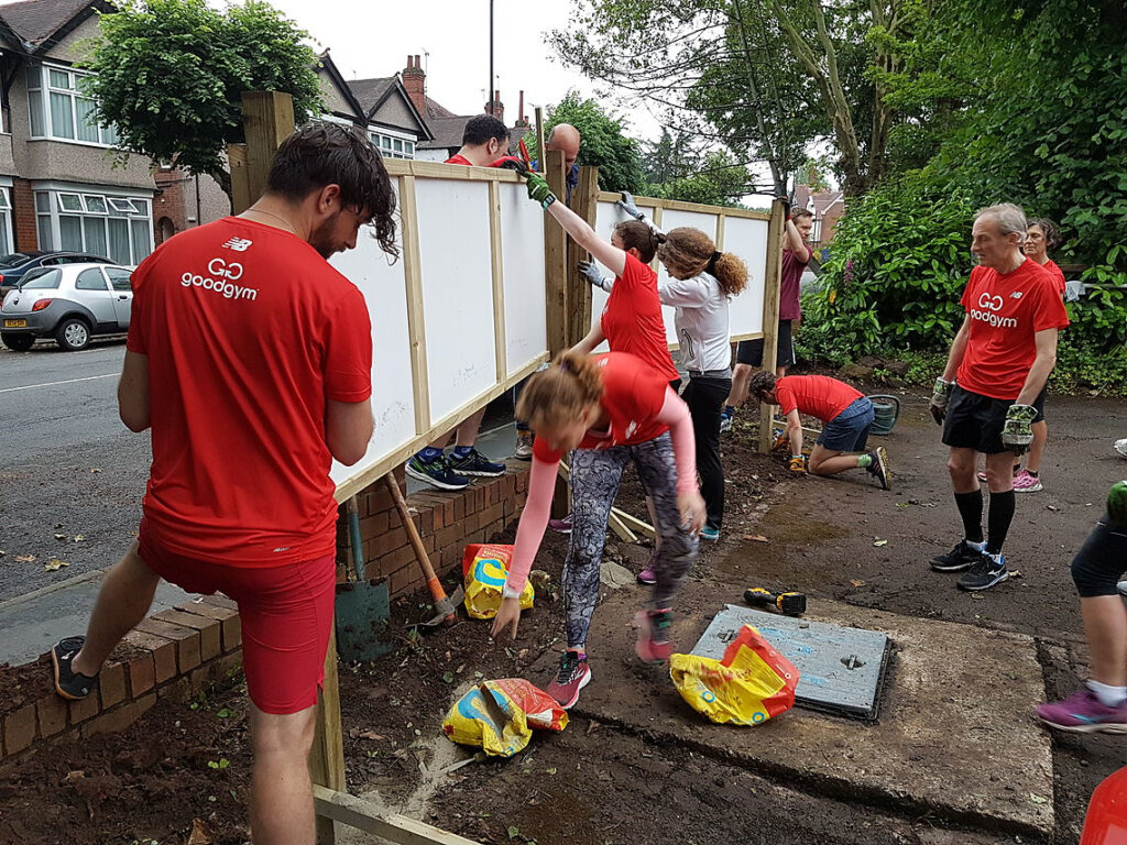 Volunteers from Good Gym putting up the charity’s front signboard